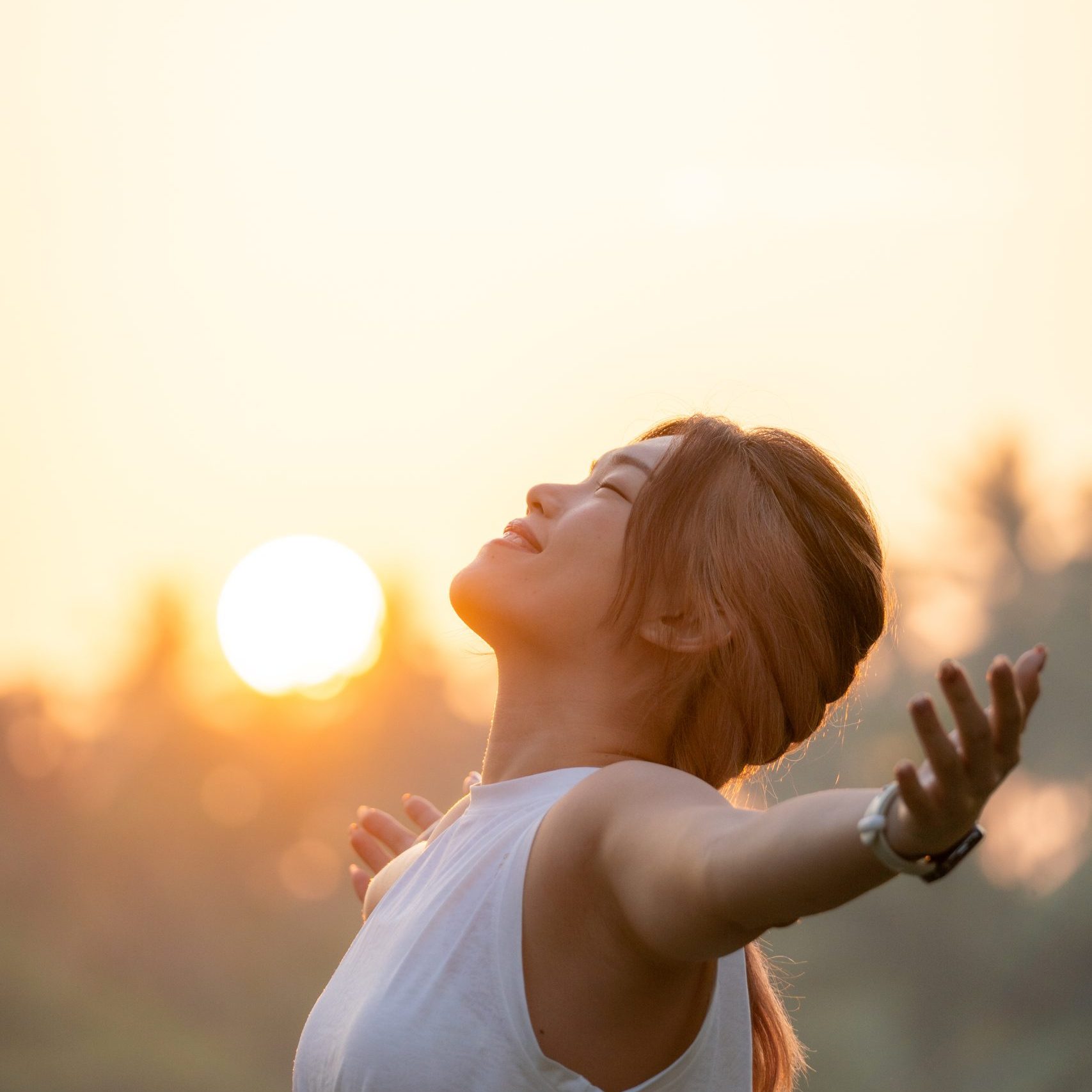Beautiful Attractive Asian woman practice yoga early in the morning during sunrise beside the pool